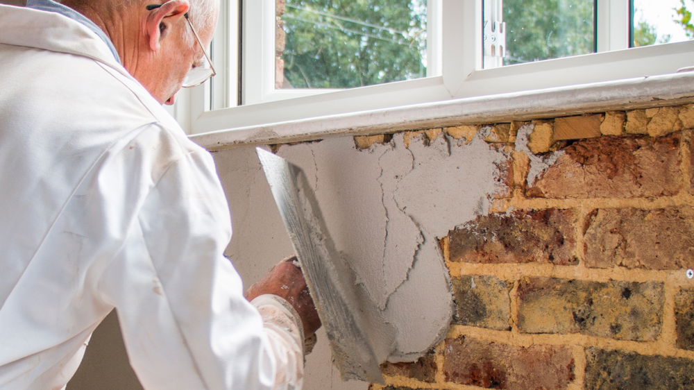 Damp proofing specialist treating an interior wall